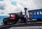 My grandson and I pose beside the smokebox of Mount Washington Cog Railway steam locomotive number 9 - Waumbek during our layover at the summit of the mountain